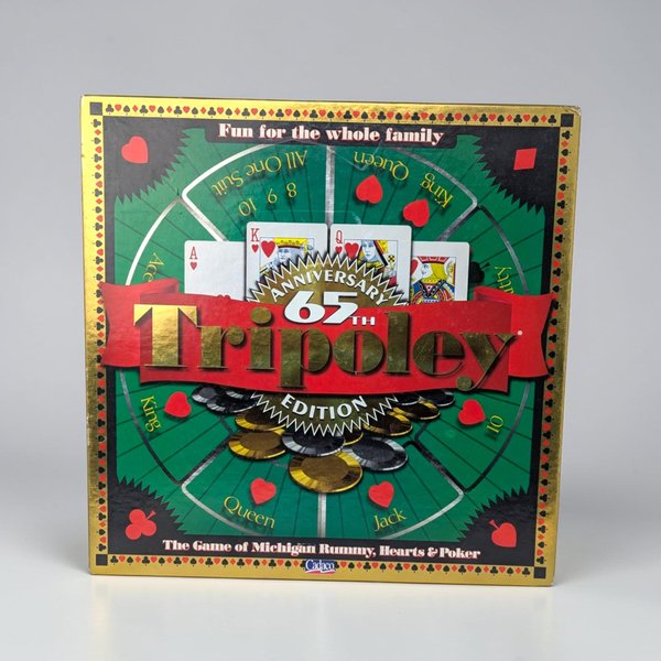 A square board game box featuring a green and gold rotating game board design. The center displays "65th Anniversary Tripoley Edition" in bold gold and red text over images of playing cards and betting chips.