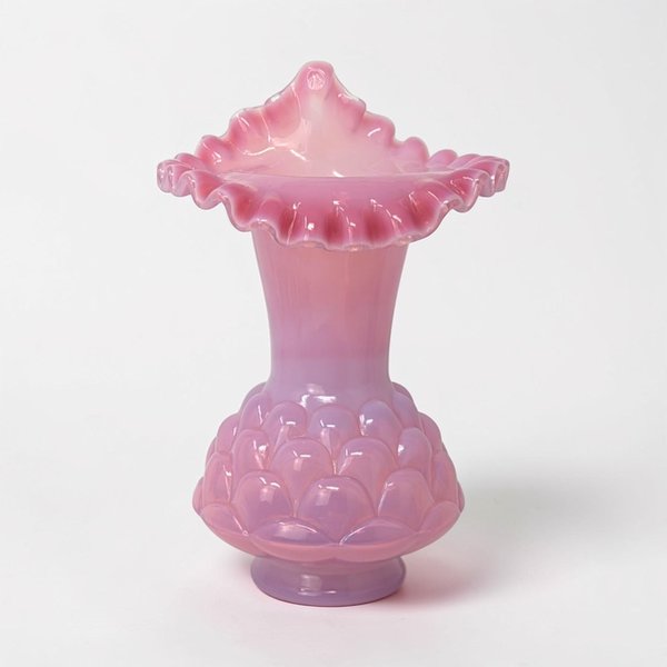 A Jack in the Pulpit glass vase in a rich plum-purple hue with a milky white opalescent rim. The body features a subtle "Jacqueline" fish scale or diamond-optic pattern with a flared, ruffled top.